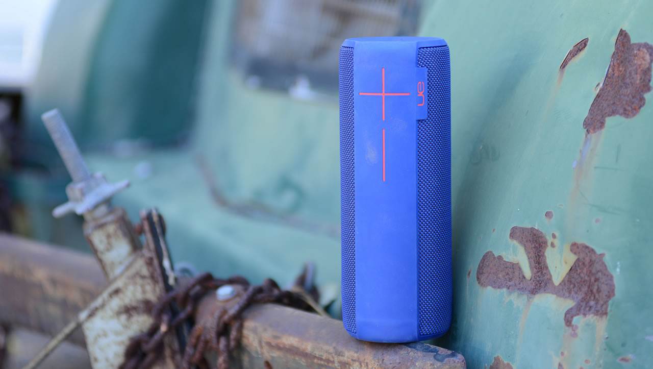 Blue UE Megaboom mobile speaker on a rusty bumper