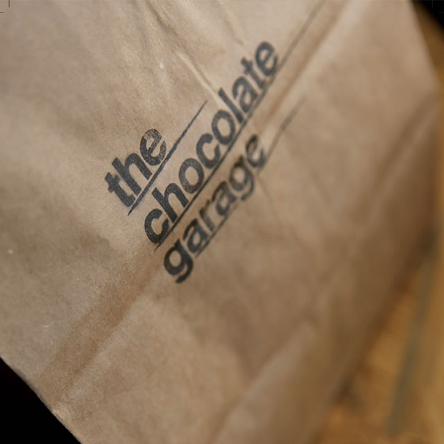 The Chocolate Garage logo on a bag