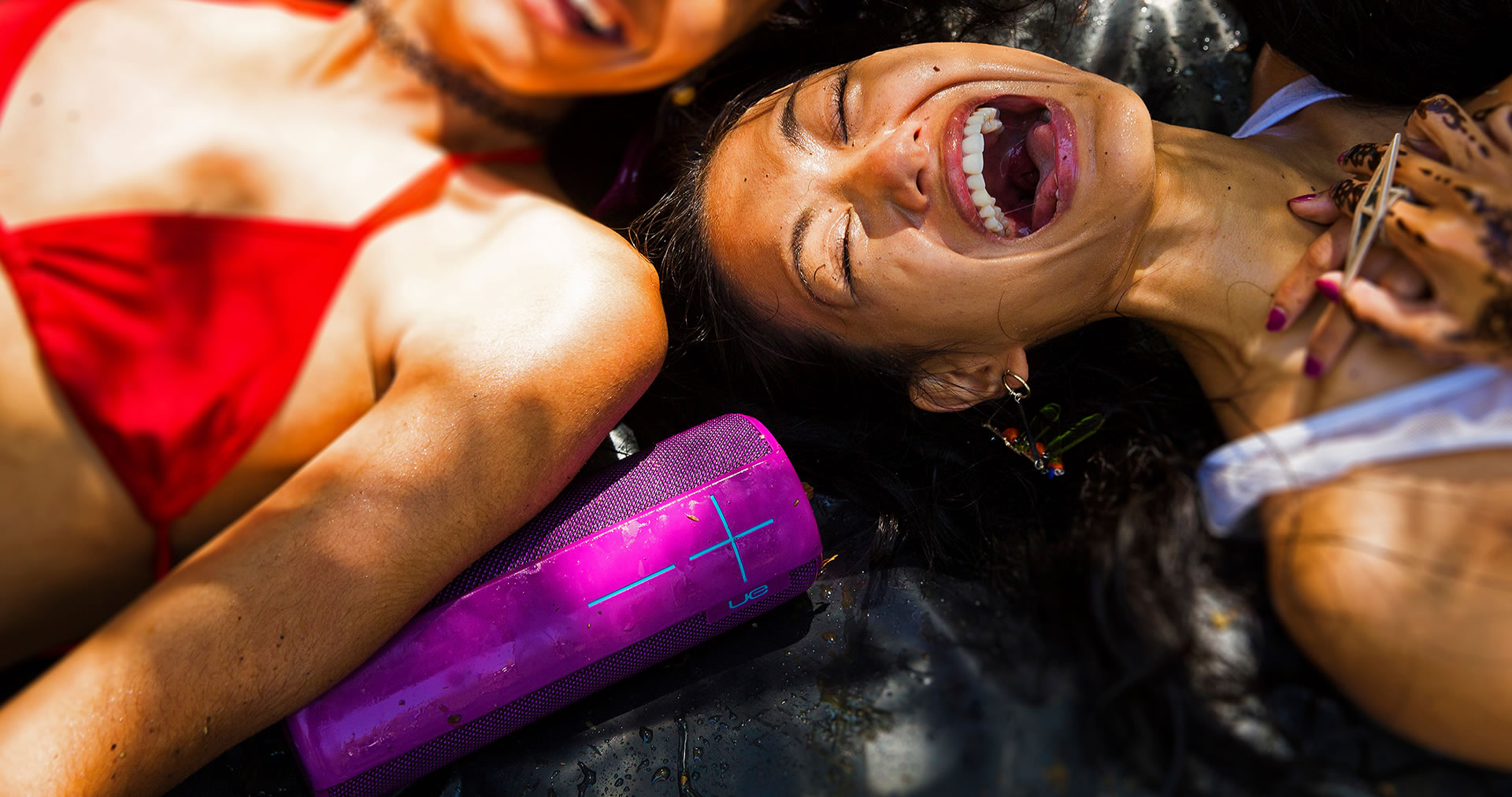 Purple water resistant UE Megaboom mobile speaker and laughing girls