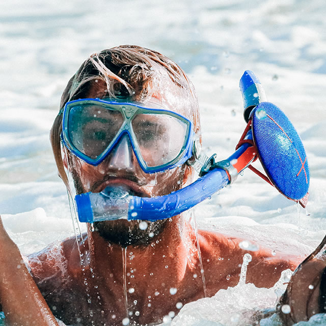 Waterproof Blue UE Roll mobile speaker on a snorkel