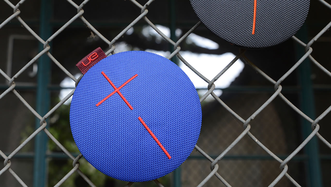 Blue UE Roll mobile speaker on a barbed wire fence