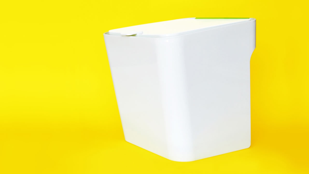 White Untrash composting can on yellow background